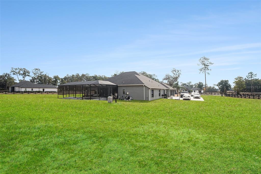 7403 Northeast 22nd Ct Road Ocala, FL 34479 - Photo 31 of 37 a view of a house with a big yard and large trees