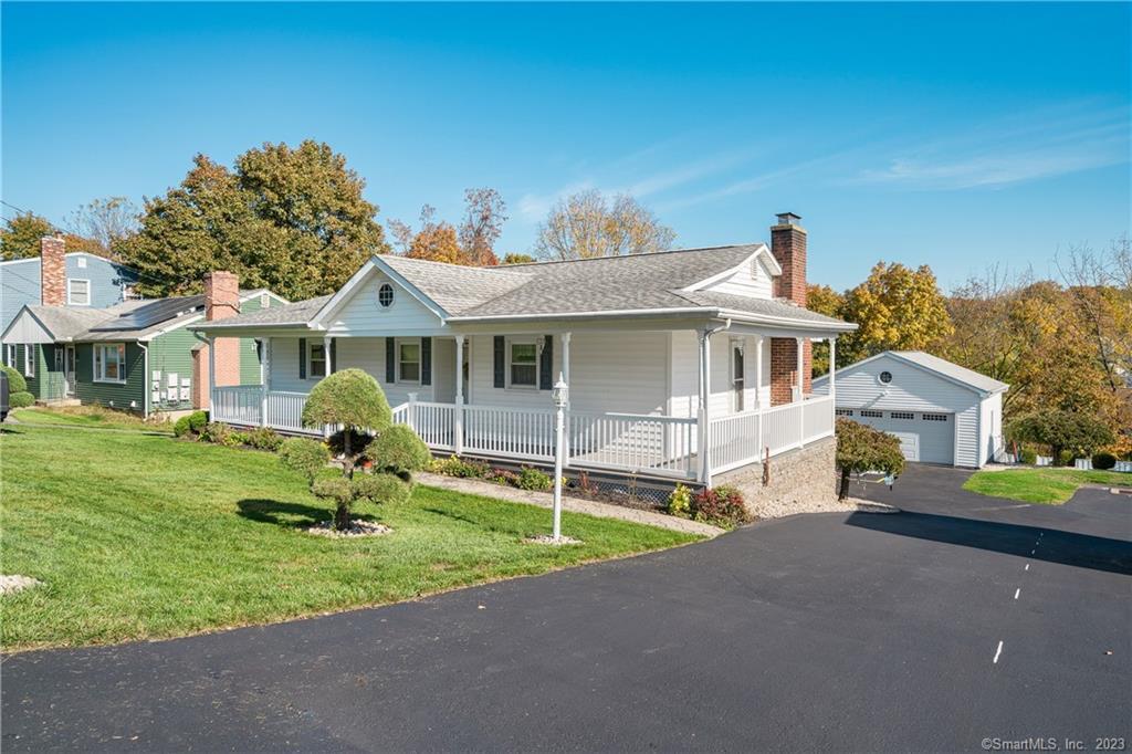a front view of a house with a garden and yard