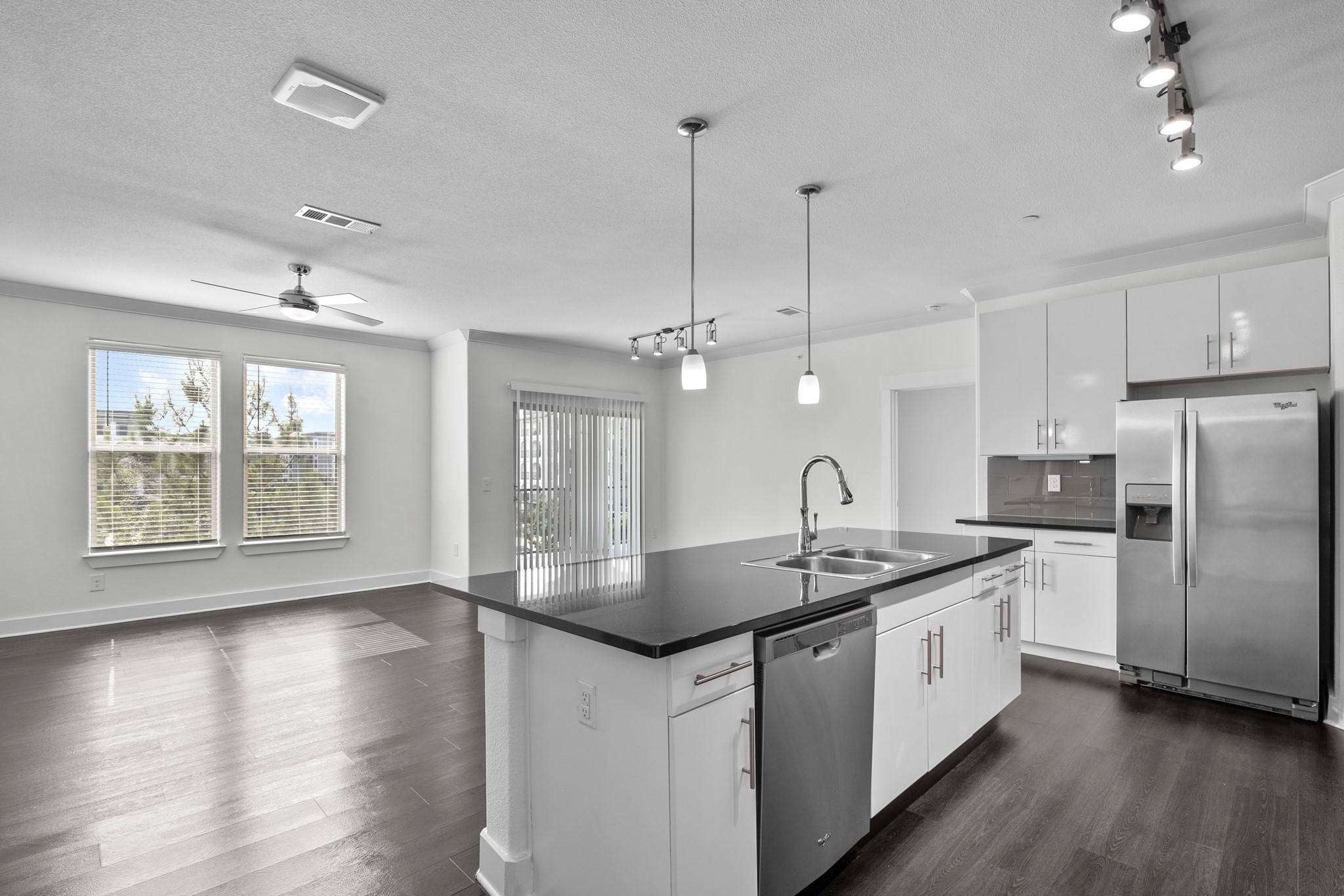 366 Fm 1488 Road, Unit 121 Conroe, TX 77384 - Photo 1 of 18 Kitchen with stainless steel appliances, dark wood-style floors, a kitchen island with sink, white cabinetry, and crown molding