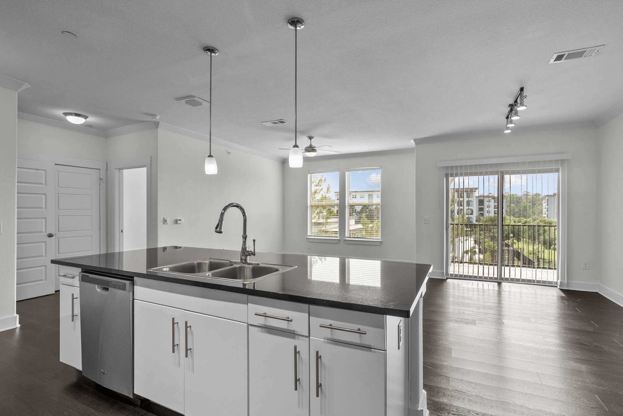 366 Fm 1488 Road, Unit 121 Conroe, TX 77384 - Photo 18 of 18 Kitchen featuring white cabinets, dark wood-style floors, dishwasher, open floor plan, and ornamental molding