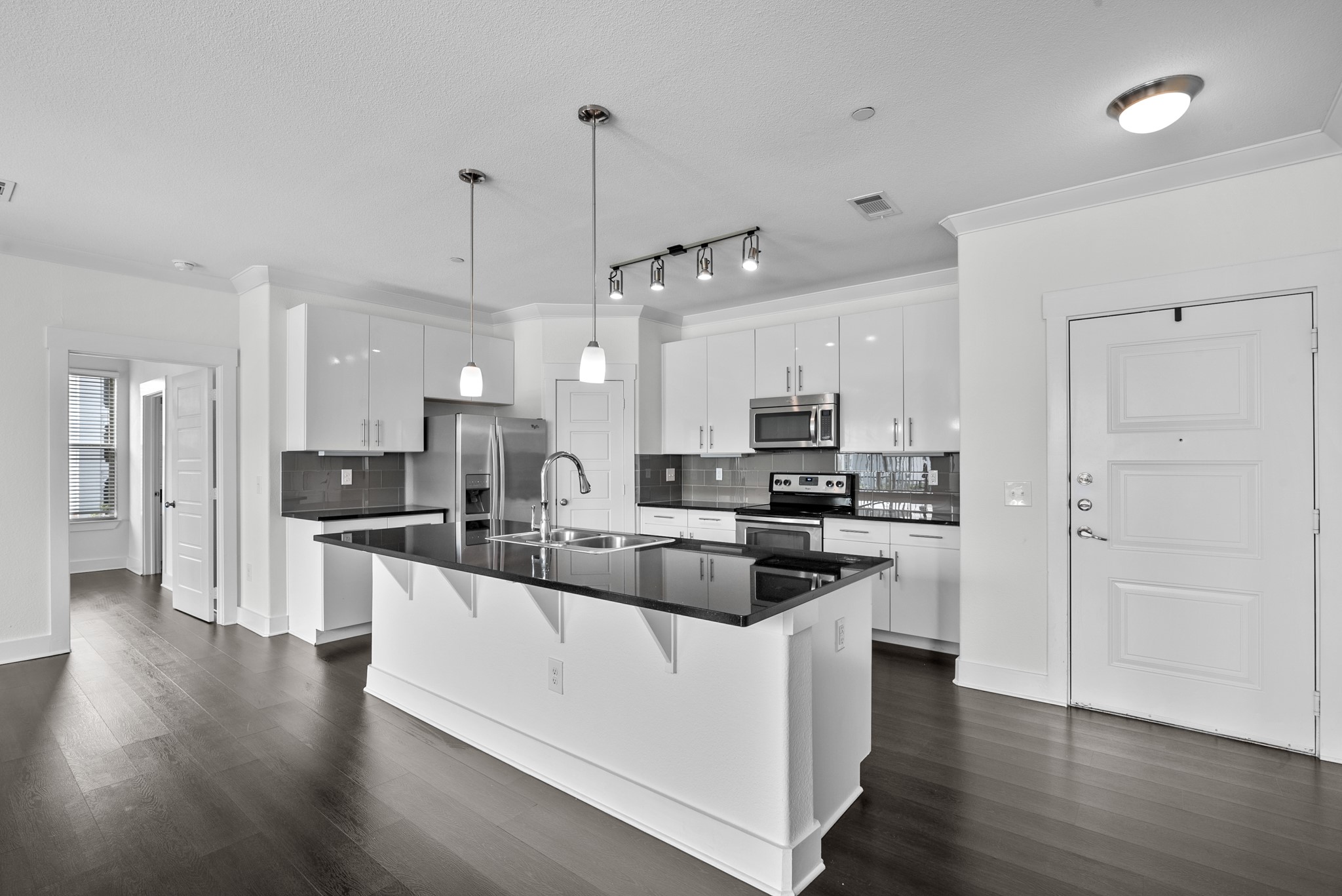 366 Fm 1488 Road, Unit 121 Conroe, TX 77384 - Photo 2 of 18 Kitchen with crown molding, decorative backsplash, a breakfast bar area, stainless steel appliances, and white cabinets
