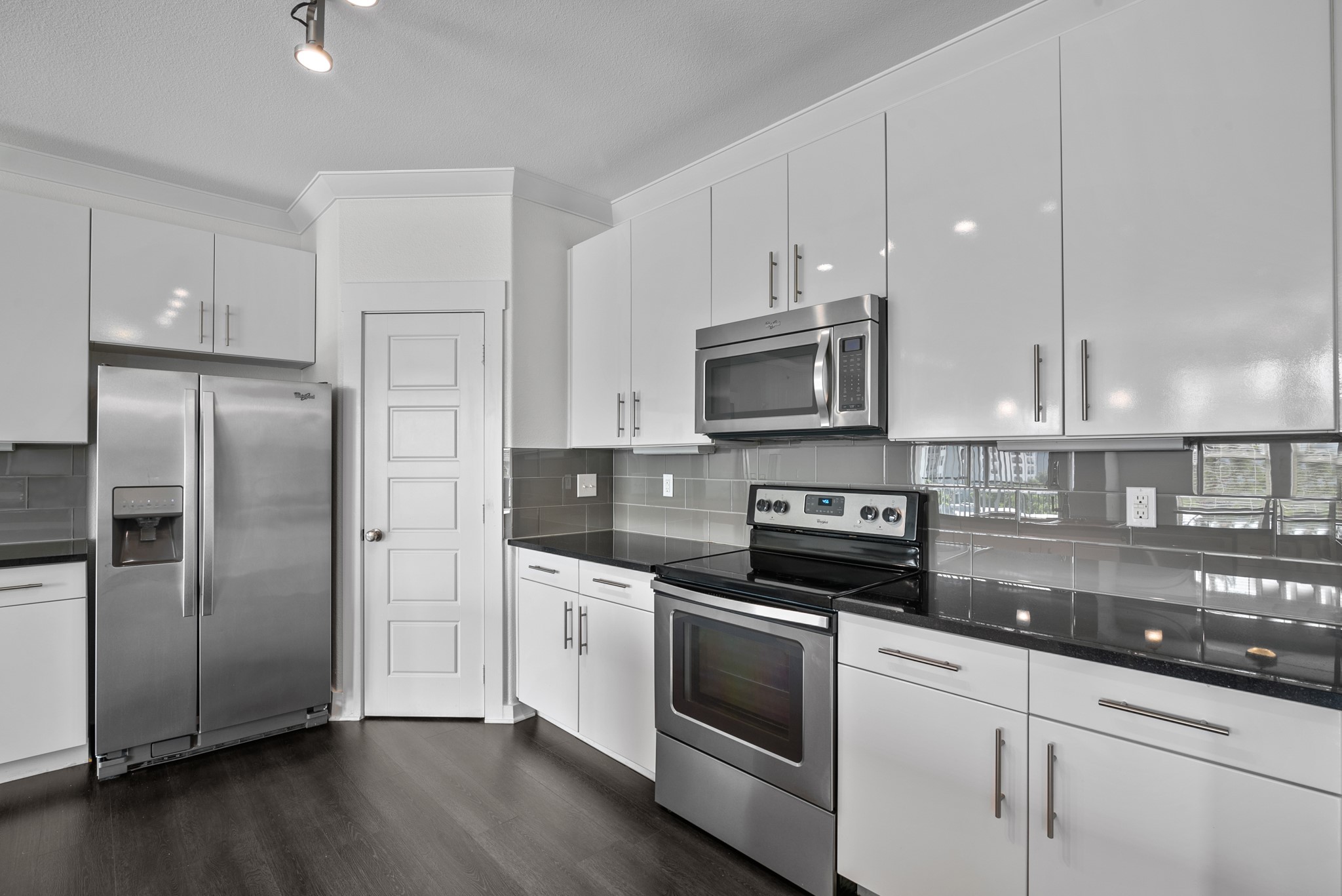 366 Fm 1488 Road, Unit 121 Conroe, TX 77384 - Photo 5 of 18 Kitchen with stainless steel appliances, white cabinets, dark wood-style flooring, backsplash, and ornamental molding