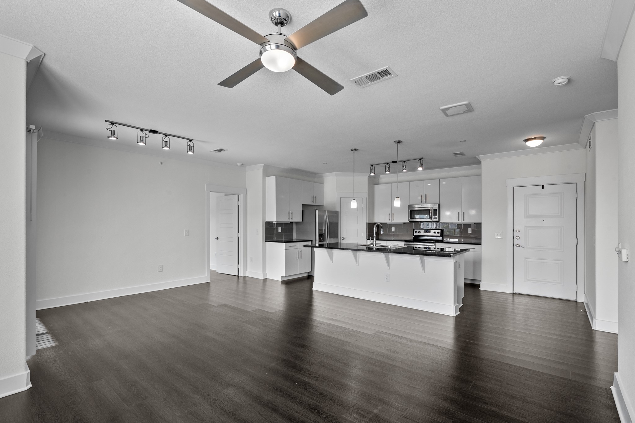 366 Fm 1488 Road, Unit 121 Conroe, TX 77384 - Photo 6 of 18 Unfurnished living room with track lighting, ceiling fan, crown molding, and dark wood finished floors