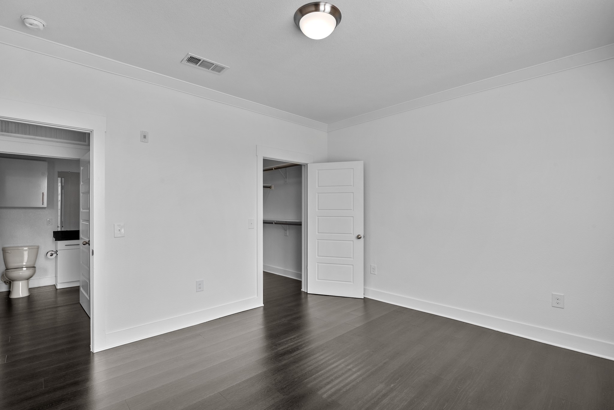 366 Fm 1488 Road, Unit 121 Conroe, TX 77384 - Photo 8 of 18 Unfurnished bedroom featuring crown molding, a spacious closet, and dark wood finished floors