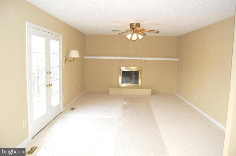 12600 Bridoon Lane Reston, VA 20191 - Photo 11 of 25 a view of an empty room with a chandelier fan