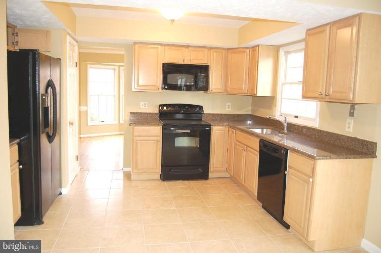 12600 Bridoon Lane Reston, VA 20191 - Photo 12 of 25 a kitchen with stainless steel appliances granite countertop a stove a sink and a refrigerator