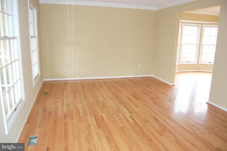 12600 Bridoon Lane Reston, VA 20191 - Photo 15 of 25 an empty room with wooden floor and windows