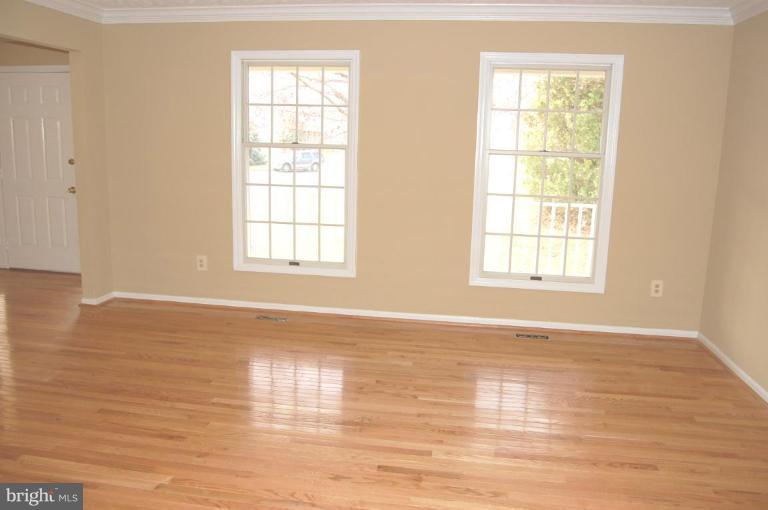 12600 Bridoon Lane Reston, VA 20191 - Photo 16 of 25 an empty room with wooden floor and windows