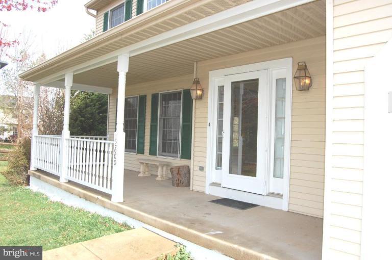 12600 Bridoon Lane Reston, VA 20191 - Photo 22 of 25 a view of a house with a small yard and wooden floor and fence