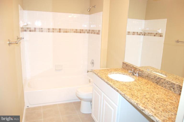 12600 Bridoon Lane Reston, VA 20191 - Photo 4 of 25 a bathroom with a granite countertop sink and a mirror
