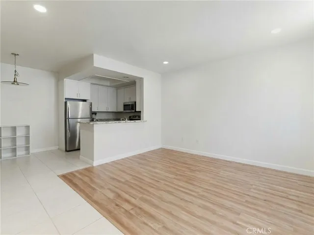 a view of kitchen with refrigerator microwave and stove