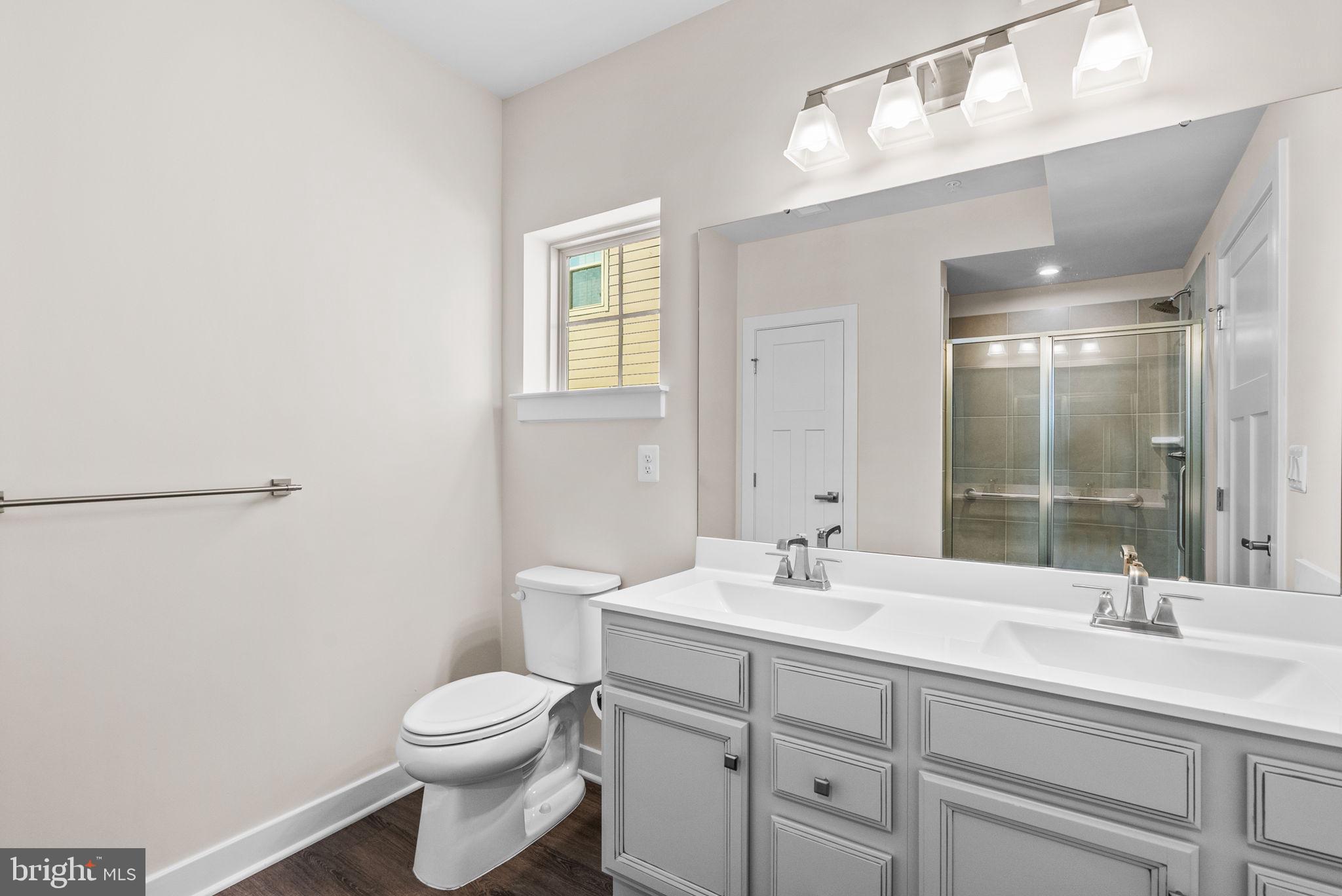 3520 Starlight Street, Unit 302 Frederick, MD 21704 - Photo 19 of 42 a bathroom with a toilet sink and mirror