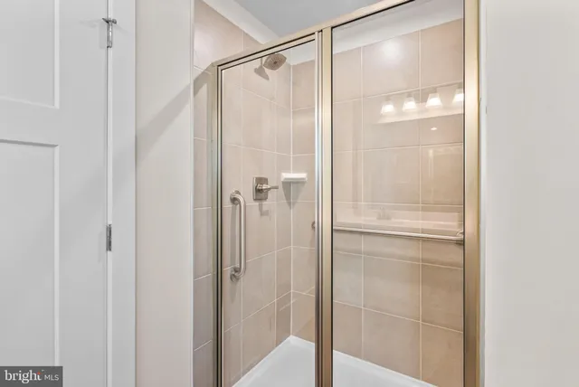 a bathroom with a glass shower door