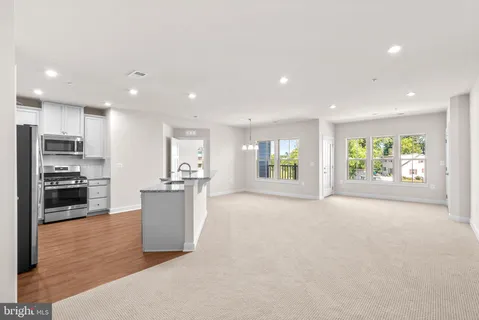 a view of a kitchen with a sink stove and refrigerator