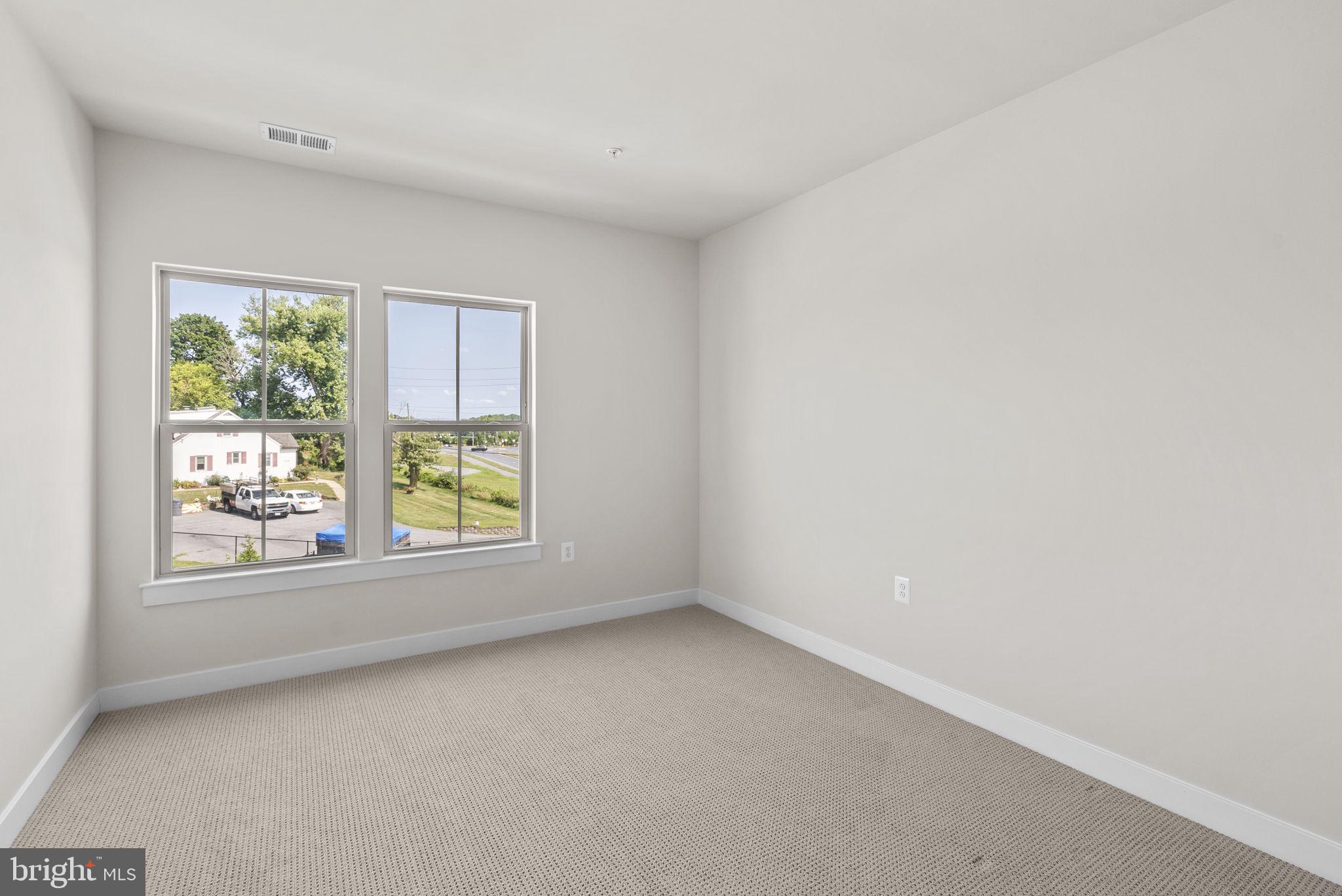 3520 Starlight Street, Unit 302 Frederick, MD 21704 - Photo 21 of 42 an empty room with windows