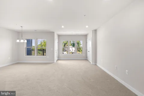 an empty room with windows and entrance