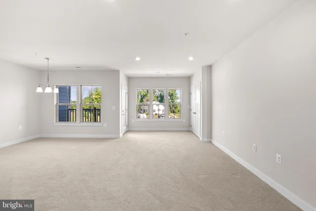 an empty room with windows and entrance