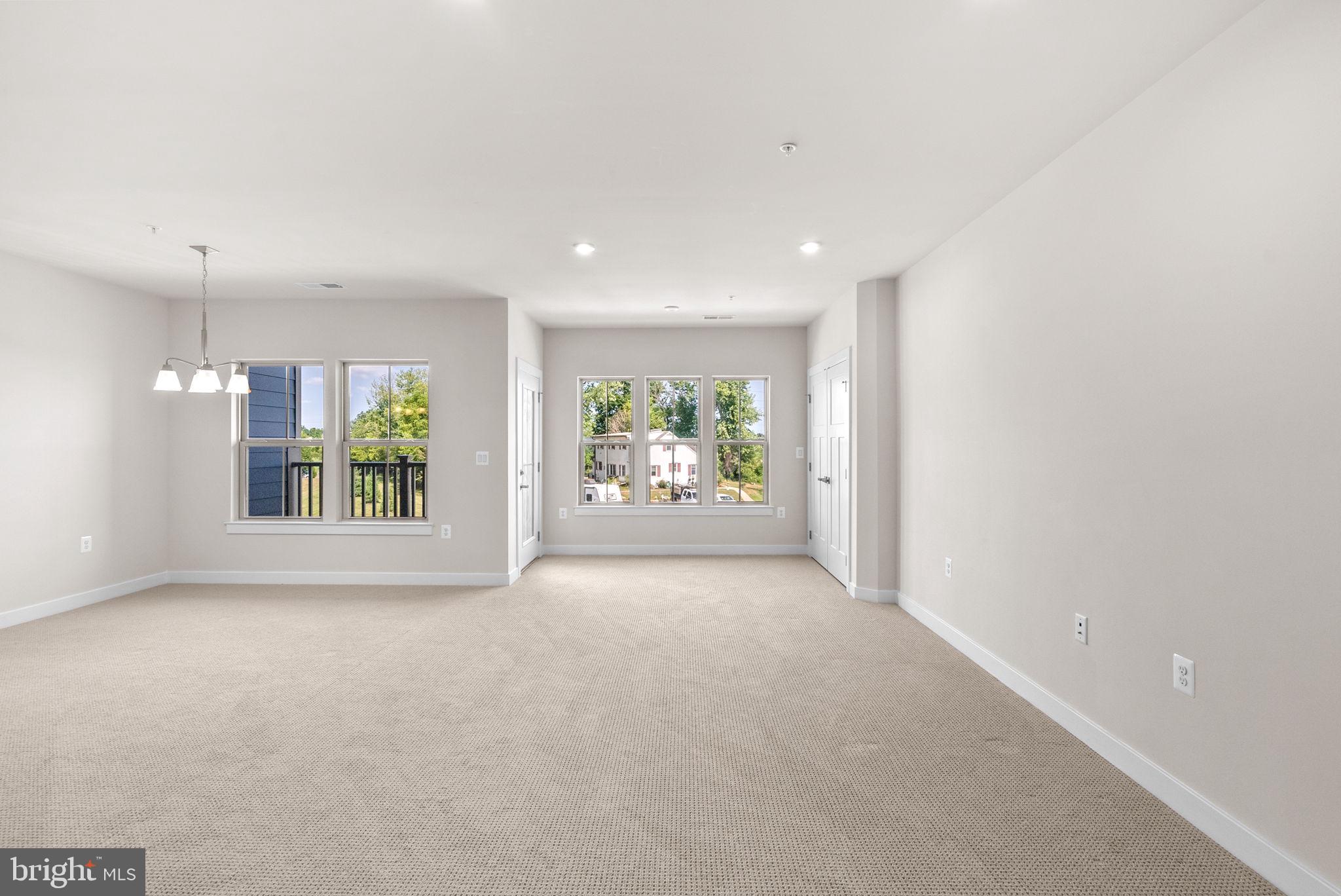 3520 Starlight Street, Unit 302 Frederick, MD 21704 - Photo 3 of 42 an empty room with windows and entrance
