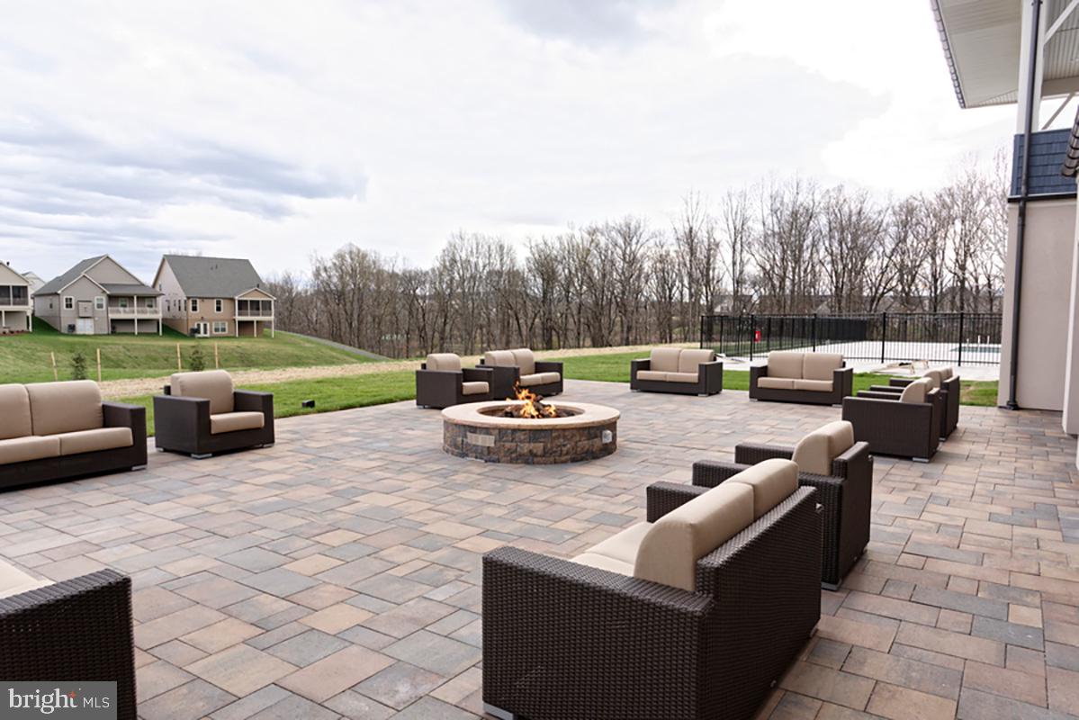 3520 Starlight Street, Unit 302 Frederick, MD 21704 - Photo 31 of 42 a view of a patio with couches and a fire pit