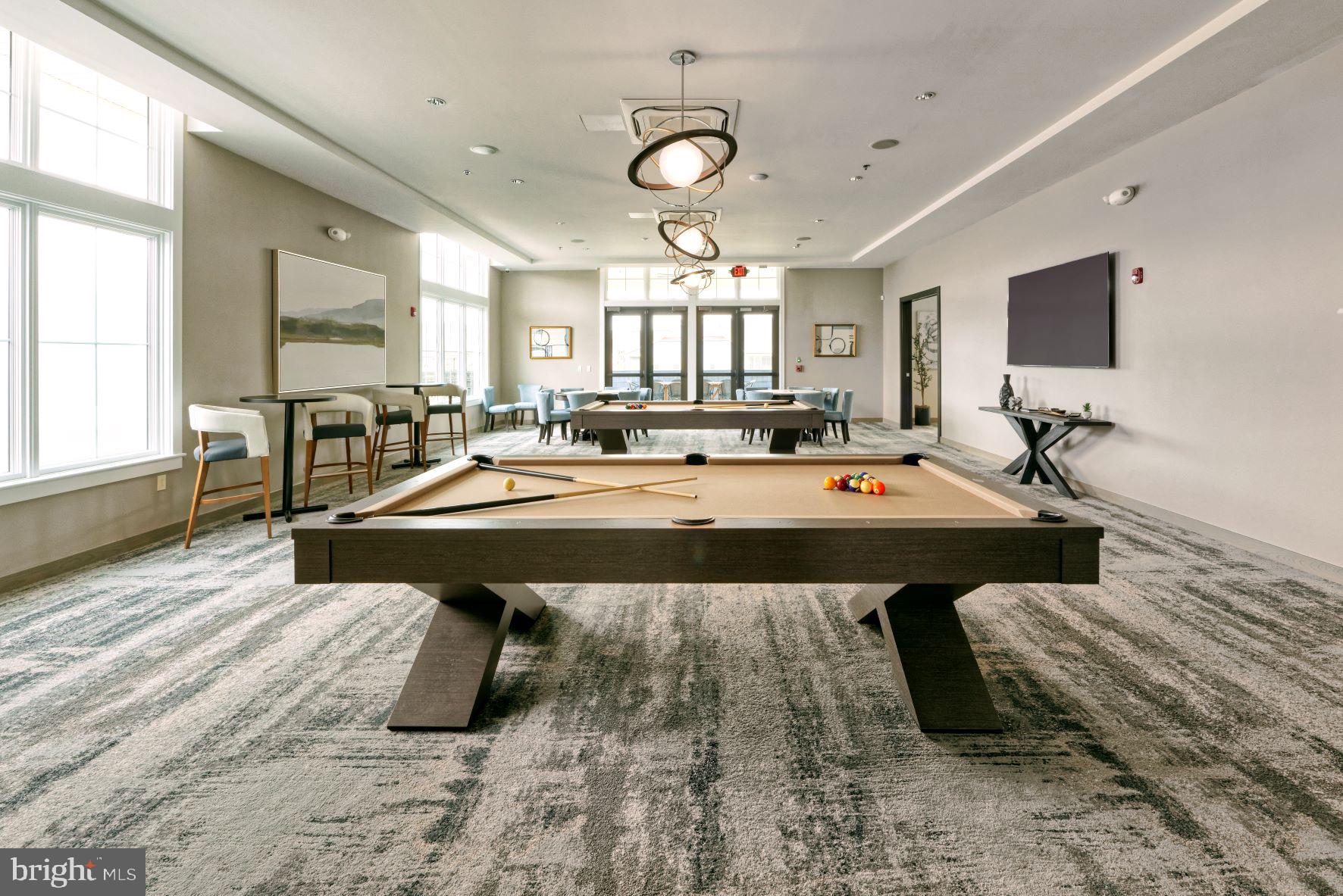 3520 Starlight Street, Unit 302 Frederick, MD 21704 - Photo 34 of 42 a living room with a table chairs and a flat screen tv