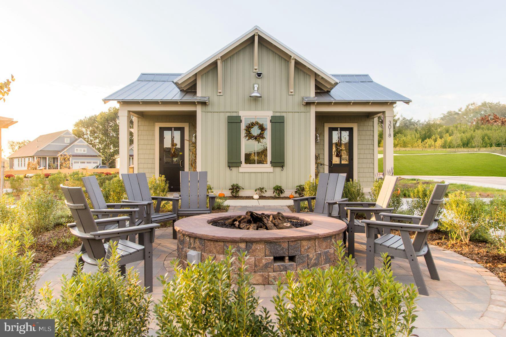 3520 Starlight Street, Unit 302 Frederick, MD 21704 - Photo 40 of 42 a view of a patio with table and chairs and potted plants