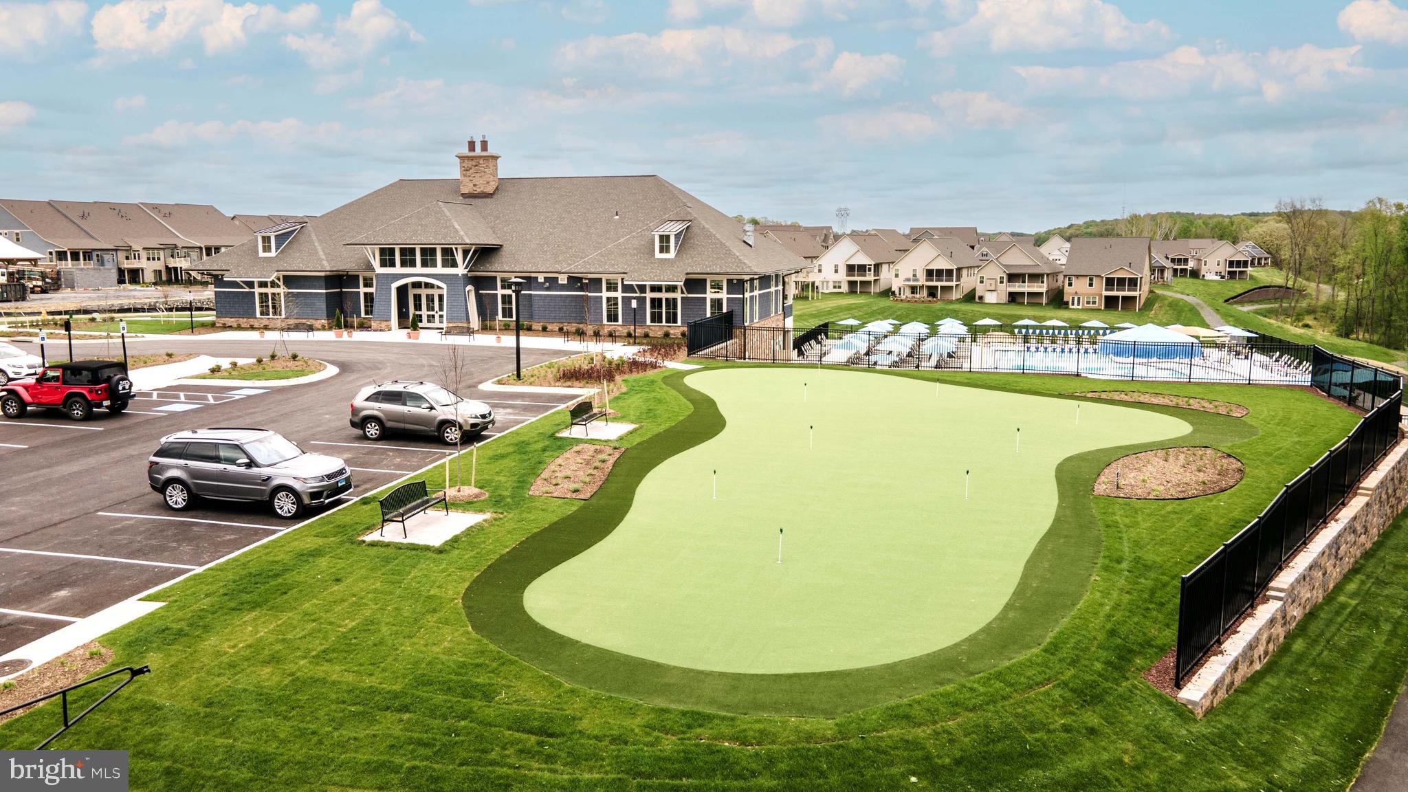3520 Starlight Street, Unit 302 Frederick, MD 21704 - Photo 41 of 42 a view of a swimming pool with a garden and seating area