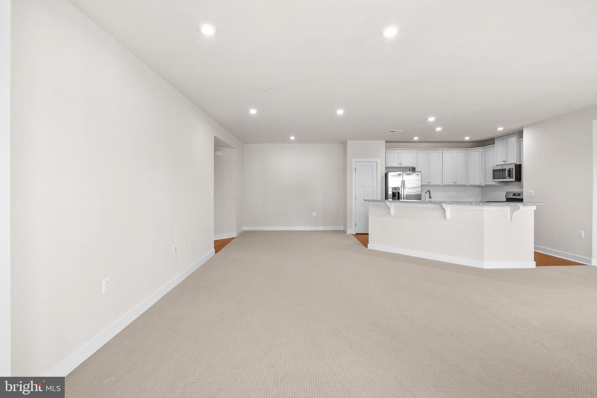 3520 Starlight Street, Unit 302 Frederick, MD 21704 - Photo 6 of 42 a view of a kitchen with a sink and a refrigerator