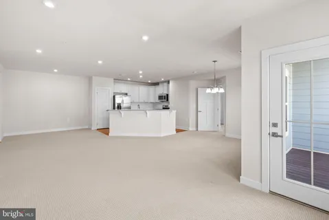 a view of a kitchen with a sink and refrigerator