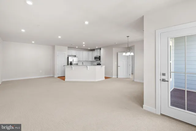 a view of a kitchen with a sink and refrigerator
