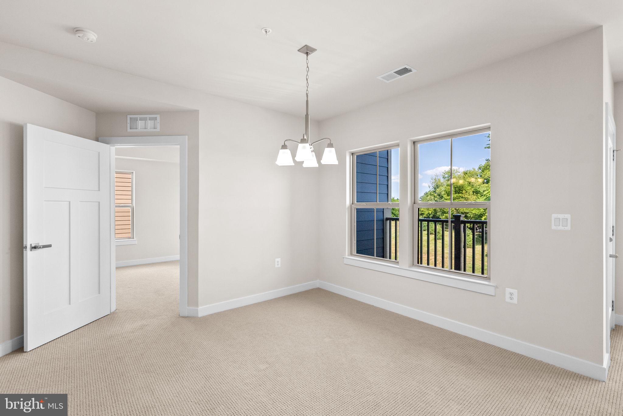 3520 Starlight Street, Unit 302 Frederick, MD 21704 - Photo 9 of 42 a view of a room with window and chandelier