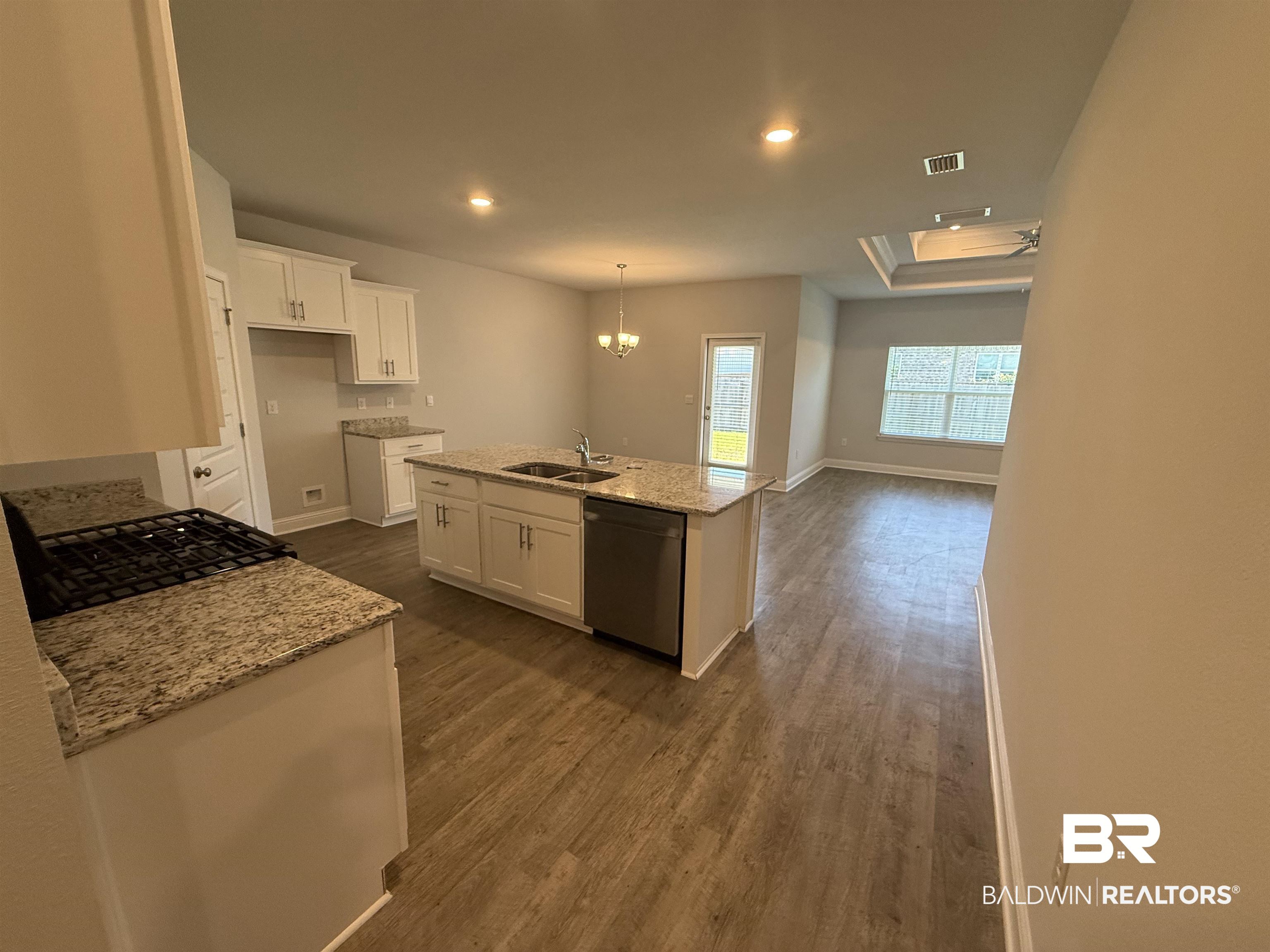 23247 Lieutenant Avenue Foley, AL 36535 - Photo 16 of 47 Kitchen with a central island featuring a double sink and integrated dishwasher