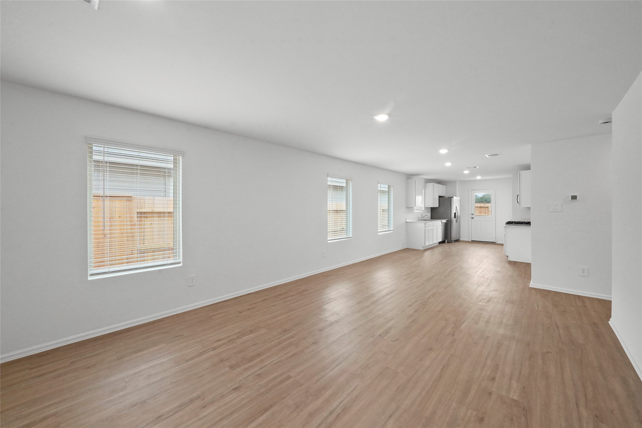 1440 Las Cuevas Drive Conroe, TX 77301 - Photo 12 of 25 a view of empty room with wooden floor and window