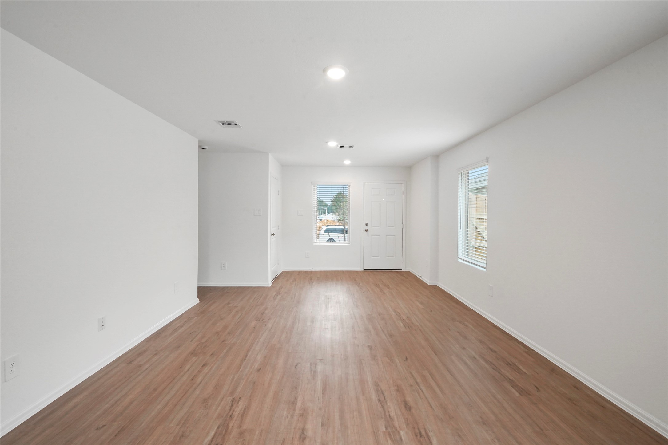 1440 Las Cuevas Drive Conroe, TX 77301 - Photo 13 of 25 an empty room with wooden floor and windows