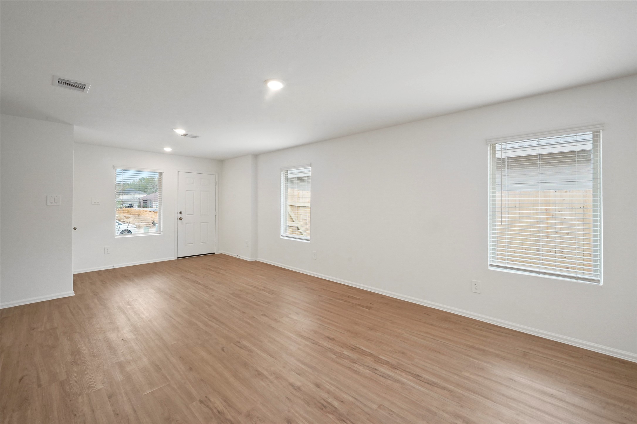1440 Las Cuevas Drive Conroe, TX 77301 - Photo 14 of 25 an empty room with wooden floor and windows
