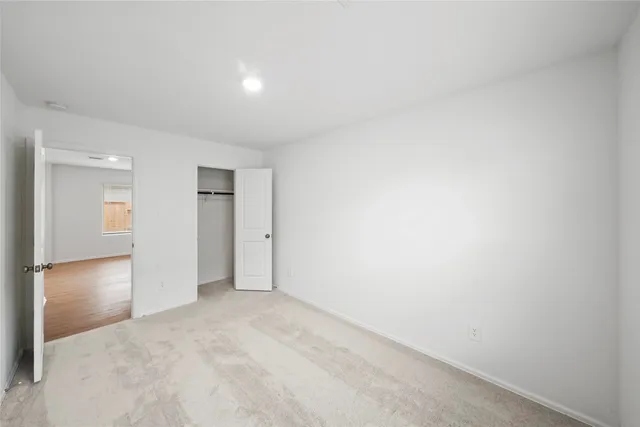 a view of an empty room and closet area