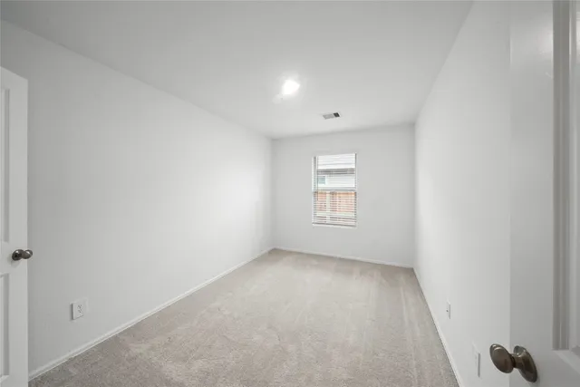 a view of an empty room and a window