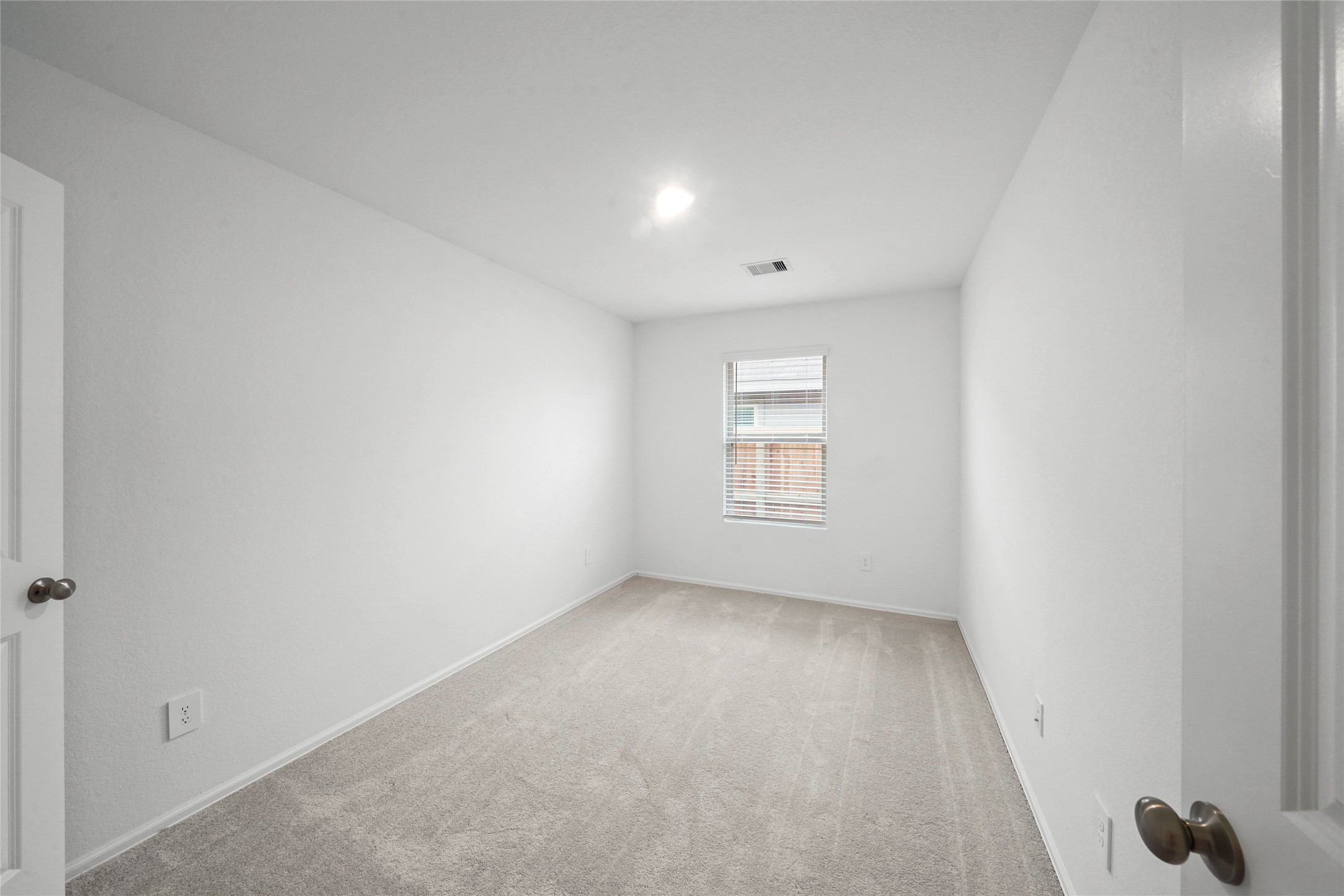 1440 Las Cuevas Drive Conroe, TX 77301 - Photo 22 of 25 a view of an empty room and a window