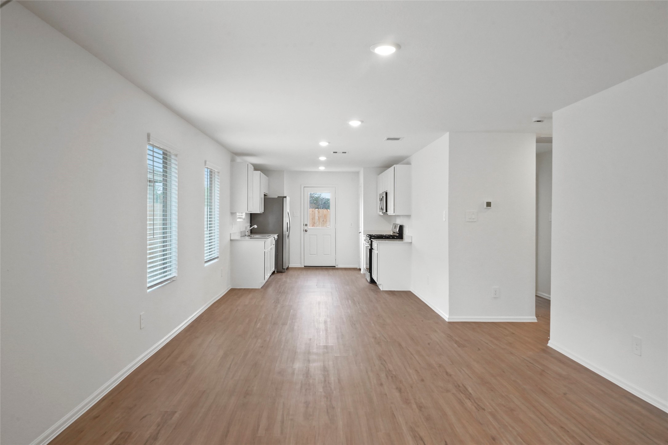 1440 Las Cuevas Drive Conroe, TX 77301 - Photo 3 of 25 a view of a big room with wooden floor and windows
