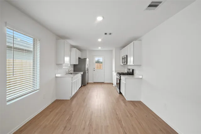 a kitchen with a sink and wooden cabinets