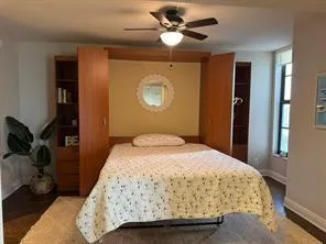 a bedroom with a bed and a chandelier