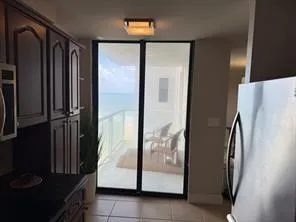 a picture of a glass door with a chair