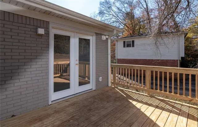 a view of a balcony with wooden floor and fence