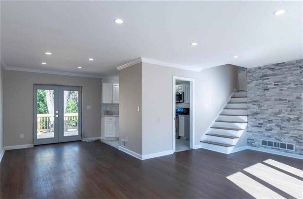 3022 Trafalgar Way, Unit 3022 Atlanta, GA 30341 - Photo 3 of 20 a view of an empty room with wooden floor and stairs