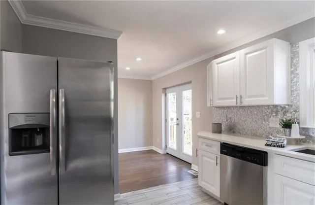 a kitchen with a refrigerator and a sink