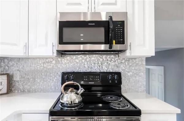 a stove top oven sitting inside of a kitchen