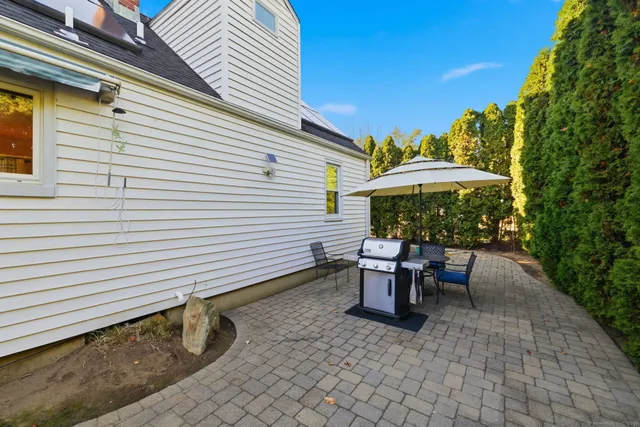 a view of a patio with a table and chairs under an umbrella