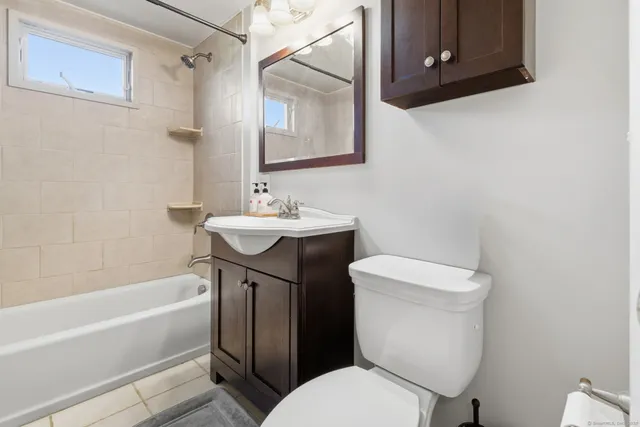 a bathroom with a sink a toilet and bathtub
