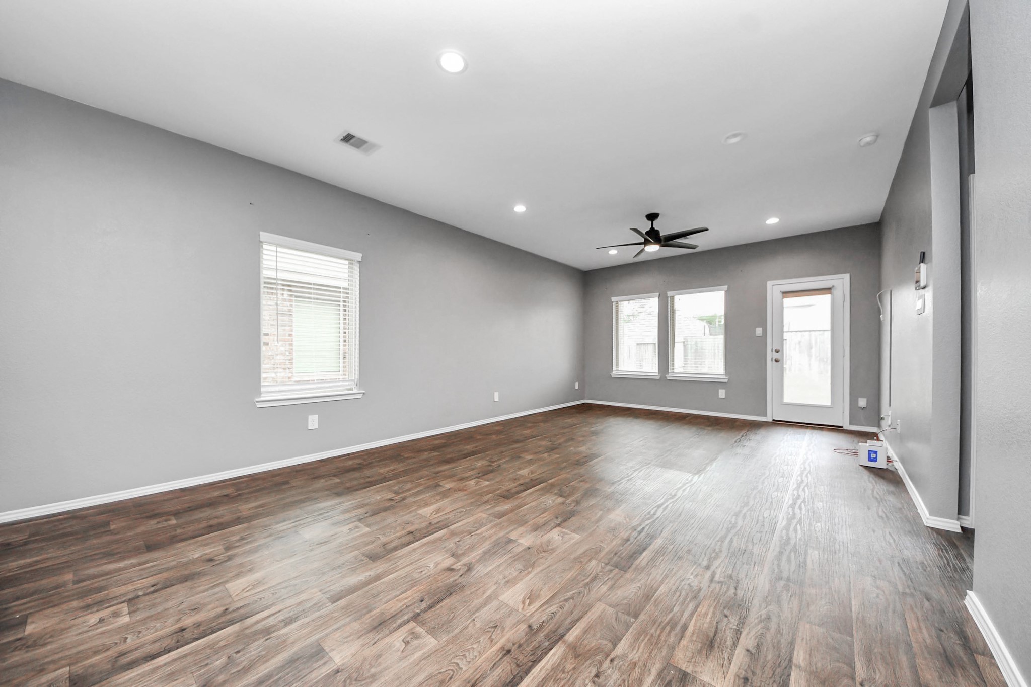 22619 Goose Pasture Lane Spring, TX 77373 - Photo 3 of 13 an empty room with wooden floor and windows