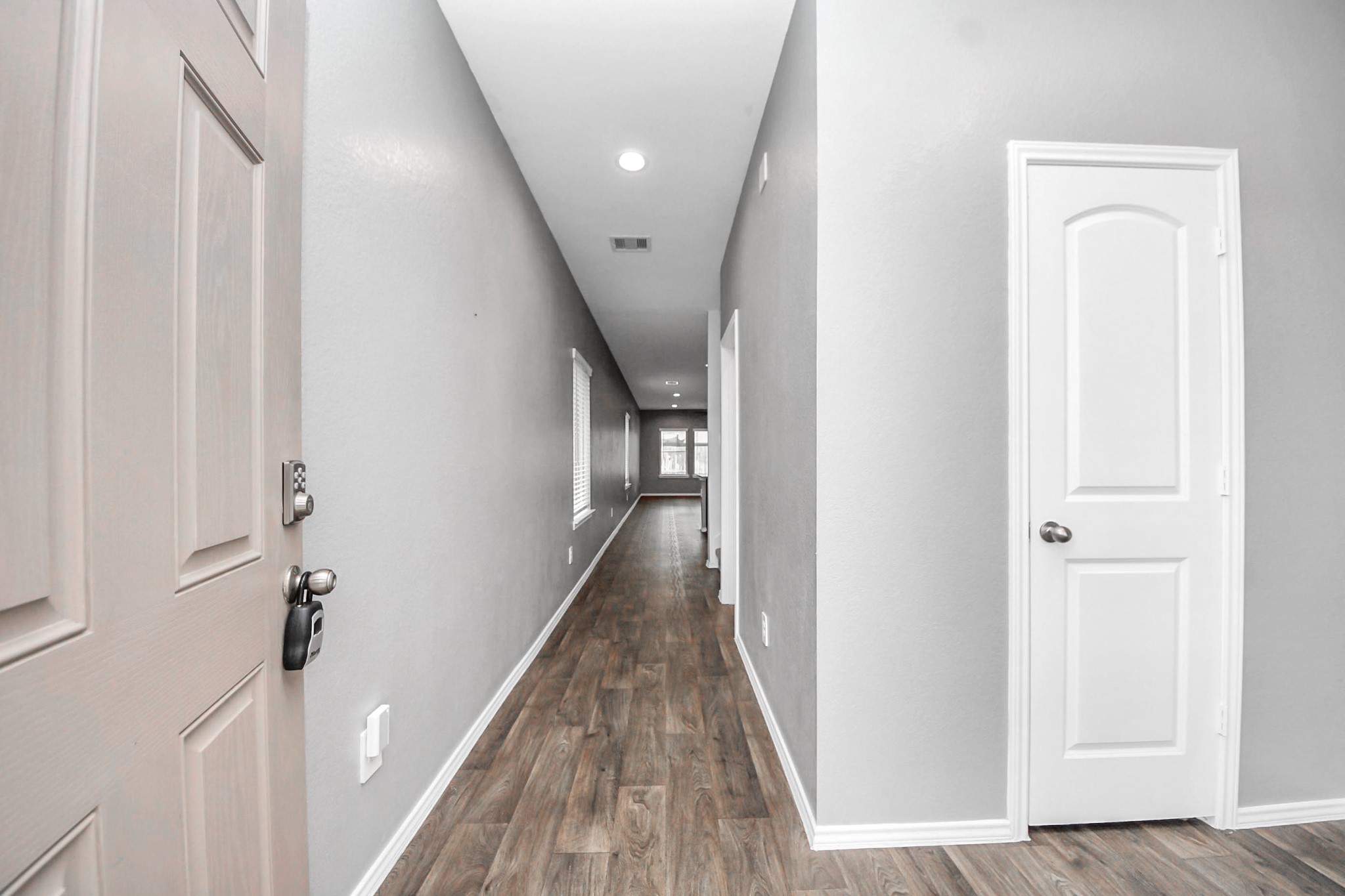 22619 Goose Pasture Lane Spring, TX 77373 - Photo 10 of 13 a view of a hallway with wooden floor and staircase