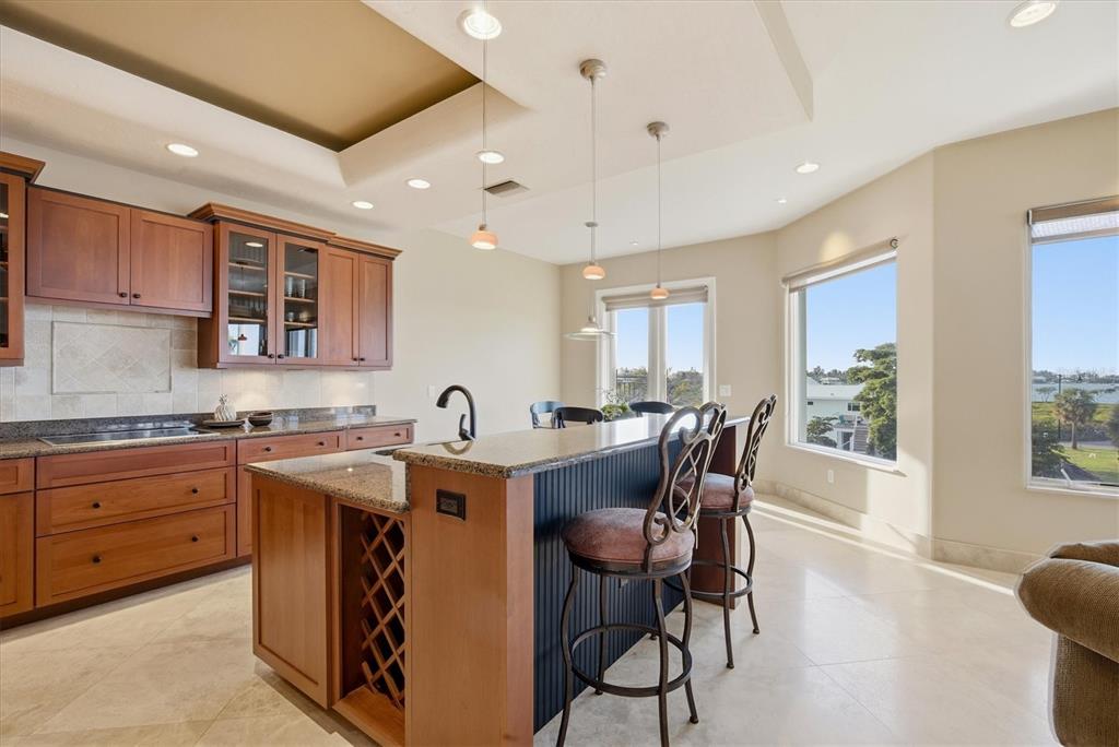 761 Norton Street Longboat Key, FL 34228 - Photo 38 of 66 a kitchen with stainless steel appliances granite countertop a table chairs sink and cabinets